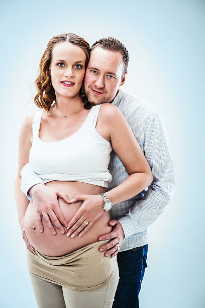 妊娠中の女性と彼女の腹に成長している男性 - human pregnancy flash ストックフォトと画像