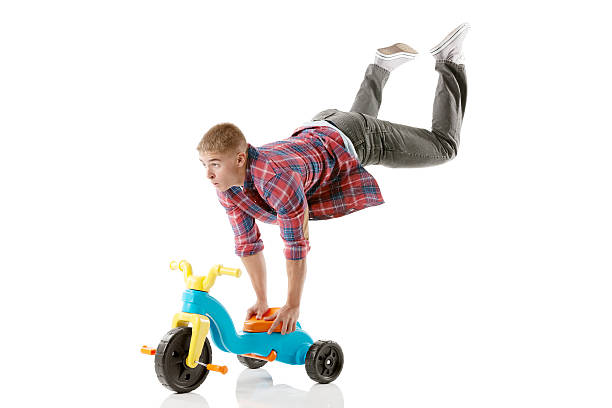 istock Man performing stunt on a tricycle 181093060