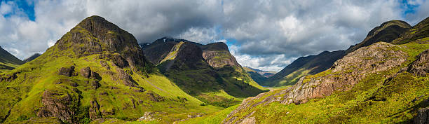 Scotland Glencoe dramatic mountain peaks panorama iconic Highland Glen "Big skies and panoramic cloudscape over the dramatic mountain peaks and iconic heather covered pass of Glencoe, the Three Sisters of Bidean nam Bian and the rocky ridge of Aonach Eagach deep in the Highlands of Scotland, UK. ProPhoto RGB profile for maximum color fidelity and gamut." glen etive photos stock pictures, royalty-free photos & images