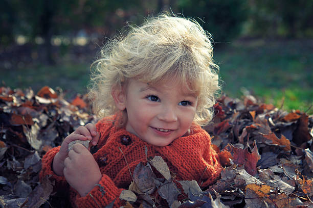 istock Child playing in the autumn leaves 181093435