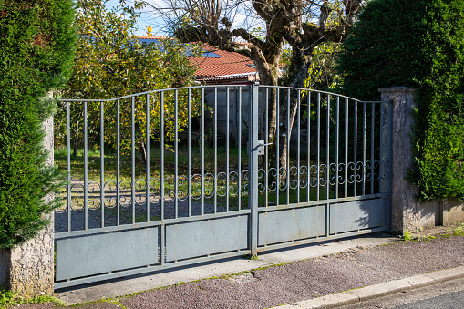 Poslingford, Suffolk, England - June 22 2016: Open gate to driveway and garage in village