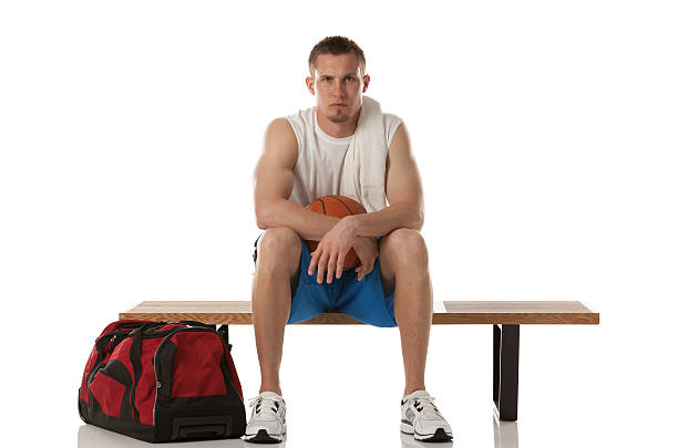 istock Serious basketball player sitting on a bench 181094125