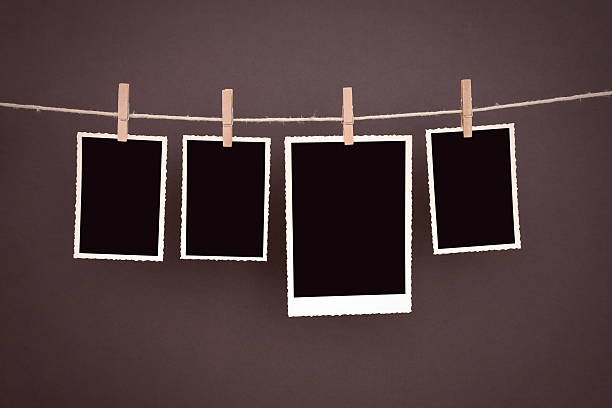 istock clothesline with old blank photos 181094495