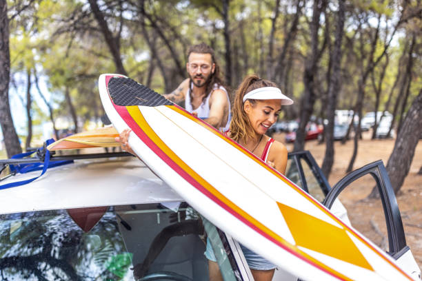 istock Young surfers taking surfboards from the car and going to beach 1810946130