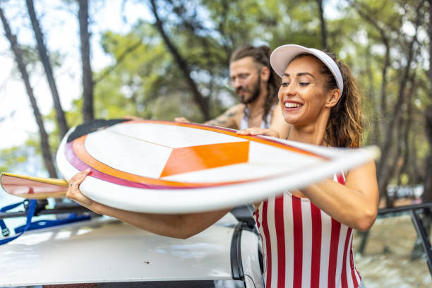 istock Young surfers taking surfboards from the car and going to beach 1810948730