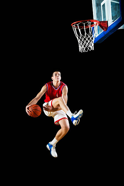 istock Basketball player slam dunking the ball. 181094947