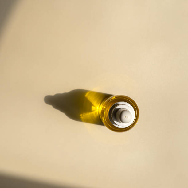 istock Cosmetic oil with pipette on brown background 1810950821