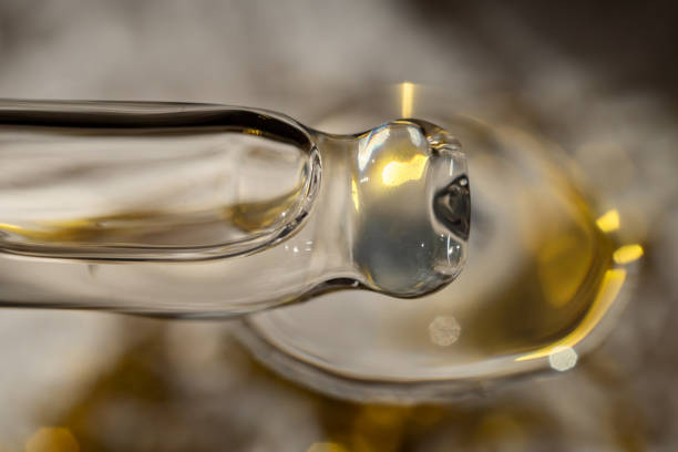istock A drop of cosmetic aromatic oil drips from the pipette. Front view. 1810950833