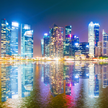 The Central Business District of the Marina Bay urban landscape in Singapore at twilight.