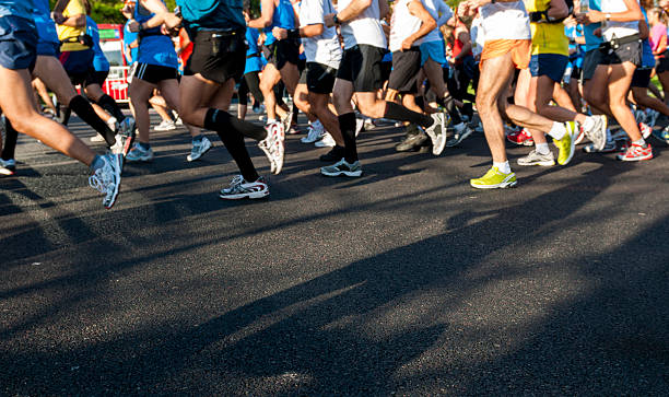 Photograph of marathon runners from waste down in motion  stock photo
