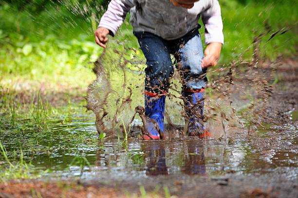 istock Toddler/ Young Child Splashing In A Muddy Paddle 181095809