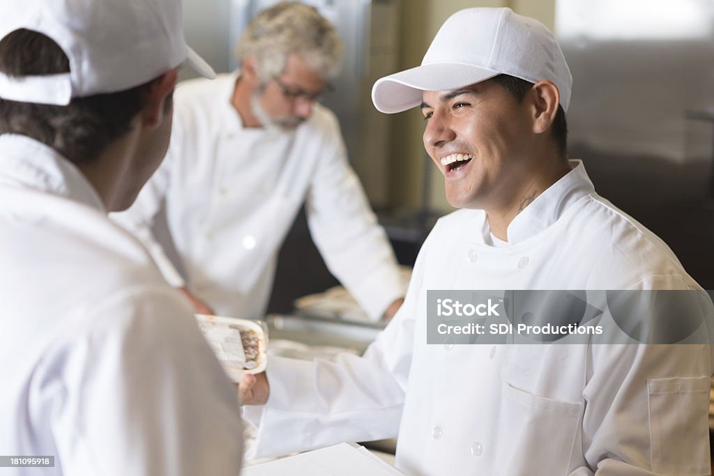 Volunteer chefs preparing frozen meals to be delivered for charity Chef Stock Photo