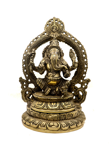 lord ganesh of hindu religion golden statue in sitting position with multiple hands, handcrafted antique statue decorated with carved details, front view isolated