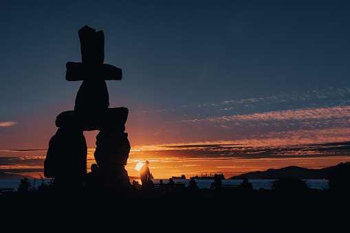 The big inukshuk meeting sun at sunset. Vancouver/Canada