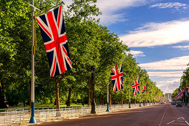 The Mall Festive decoration with Union Jack flags on The Mall leading to Buckingham Palace. buckingham palace photos stock pictures, royalty-free photos & images