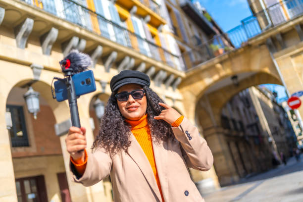 istock Stylish latin streamer broadcasting a life video visiting a city 1810971293