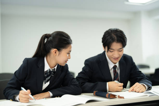 istock Asian teenagers in high school uniforms studying in class 1810972895