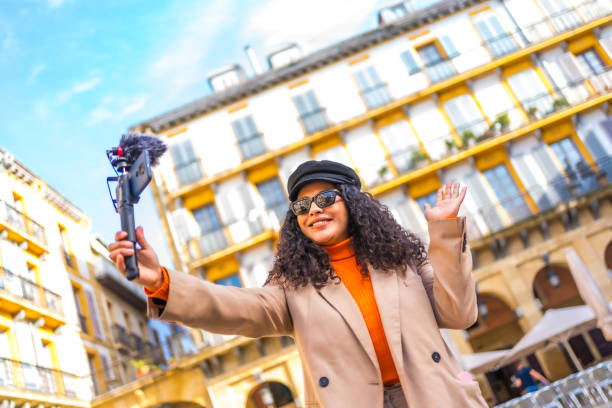 istock Influencer performing a life video visiting a city in winter 1810973463