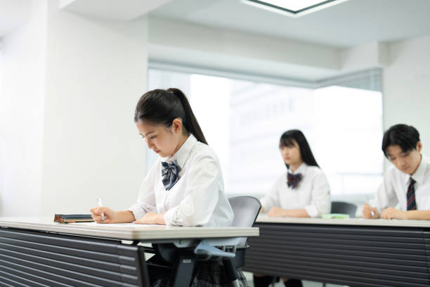 istock Asian teenagers in high school uniforms studying in class 1810973996