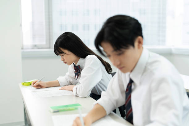 istock Asian teenagers in high school uniforms studying in class 1810974510