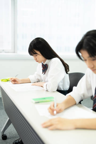 istock Asian teenagers in high school uniforms studying in class 1810974512