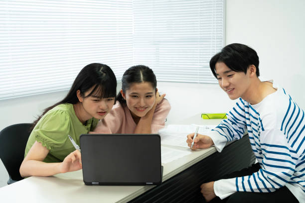 istock Asian teenagers using a laptop in discussion 1810977267