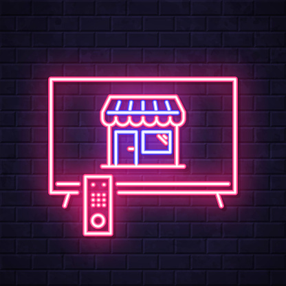 istock Online shopping with TV. Glowing neon icon on brick wall background 1810978336