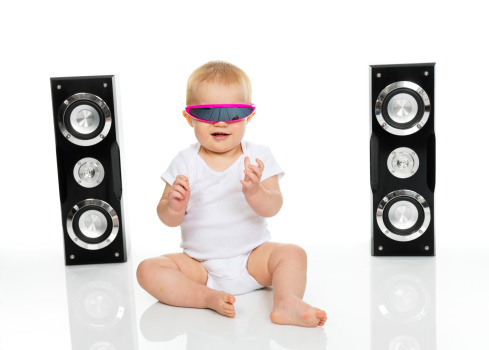 A baby with robot / 80's glasses listening to music