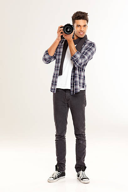istock Young man clicking photo from camera 181098686