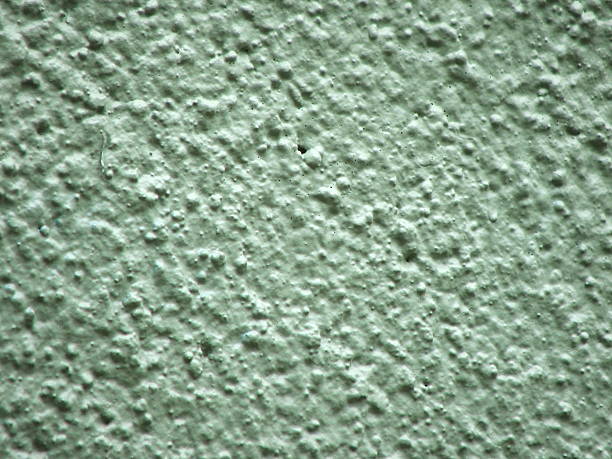 Rough Green Texture Thickly painted rough concrete with pits stetner stock pictures, royalty-free photos & images