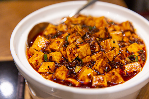 Hot Pot of Authentic Sichuan-Style Mapo Tofu in a Restaurant Setting, Spicy and Satisfying, zoom-in view