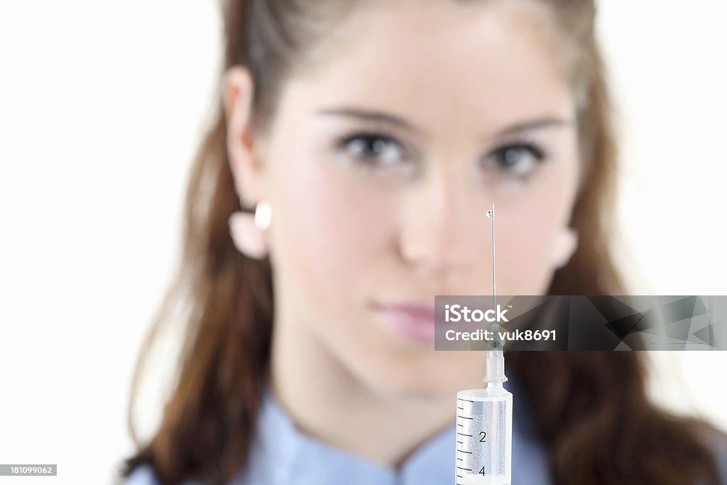 Nurse preparing syringe Nurse preparing syringe in front of white background 20-24 Years Stock Photo