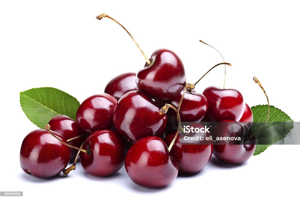 A pile of cherries with leaves attached Cherry heap with Leafs Cherry Stock Photo