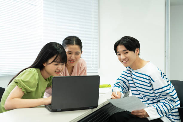 istock Asian teenagers using a laptop in discussion 1810991748