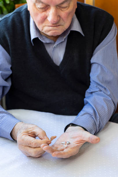 istock Adult senior preparing hearing aid for use 1810994968