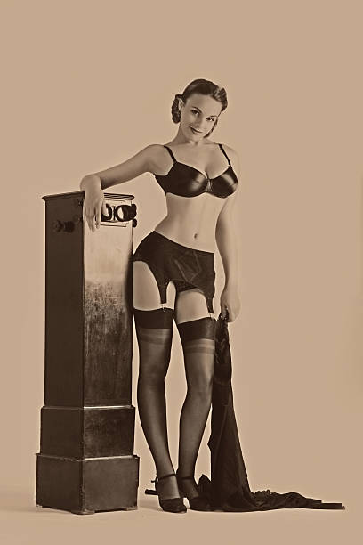 Pin-up Style. Stereo unit Emulation of vintage style photography in pin-up style. Young woman standing near the old stereo unit pin up girl photos stock pictures, royalty-free photos & images