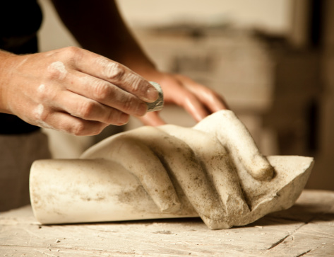 Hands of senior woman sculpting clay vase on potter's wheel at pottery training lesson. Hands of girl craftswoman, teaching pottery craft. Hobby concept