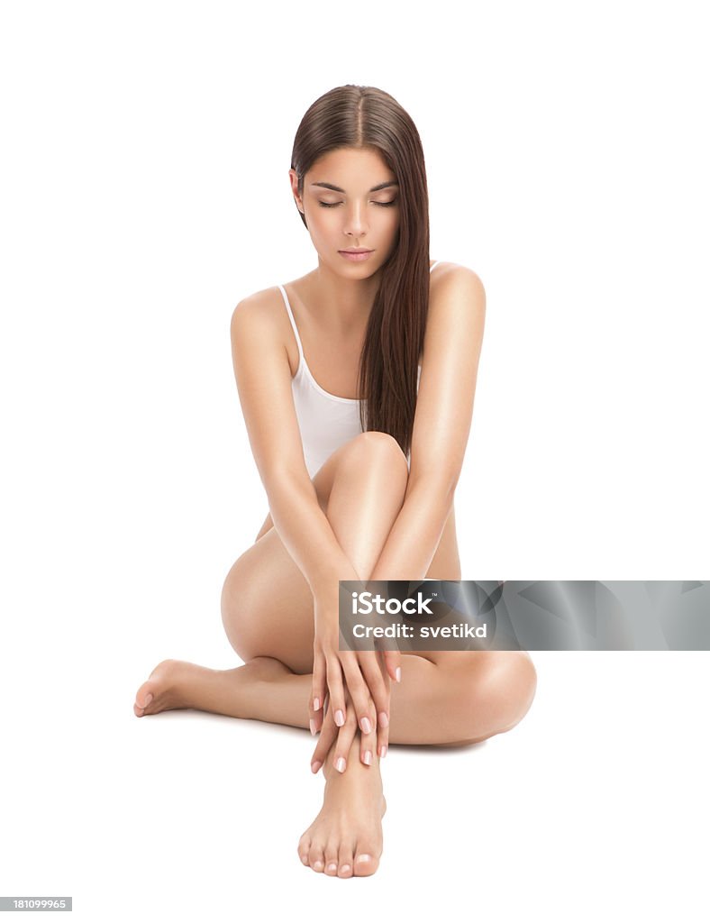 Body care. Woman with perfectly shaped body holding hands on her legs. Body care. Women Stock Photo