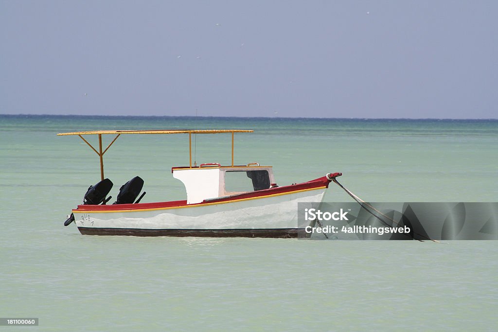 Small Fishing Boat on the Caribbean Sea in Aruba Small Fishing Boat on the Caribbean Sea in ArubaWant to select from more Aruban fishing boats Aruba Stock Photo