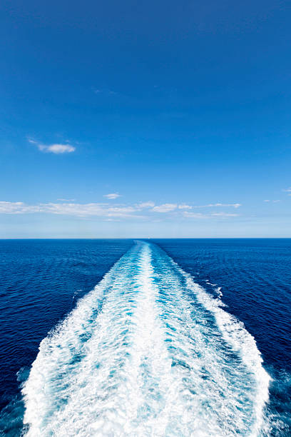 Cruise ship track with calm sea and clear sky stock photo