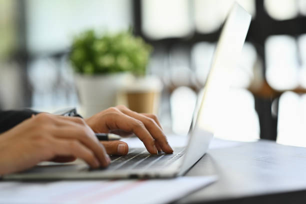istock Closeup male worker typing on keyboard answering email or searching information on laptop 1811006221