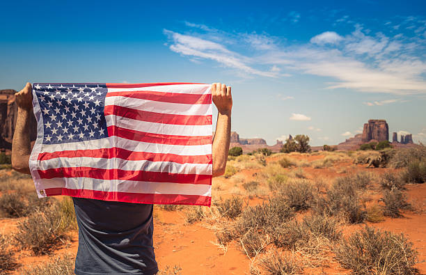 istock Tourist with flag on Monument valley National park 181100630