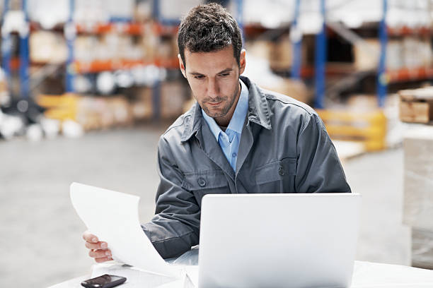istock Young man with white laptop, holding paper 181100862