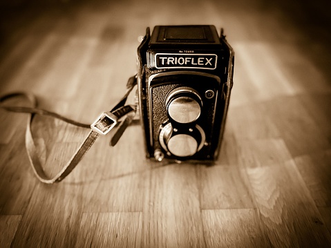 Helsingborg, Sweden – December 09, 2021: A vintage Trioflex camera on a flat wooden surface