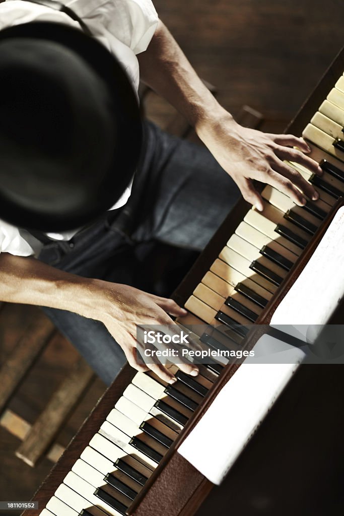 The makings of a creative genius High-angle view of a young musician playing the piano Bar - Drink Establishment Stock Photo