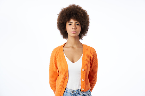 portrait of a latina woman with afro hairstyle and orange jacket on white background