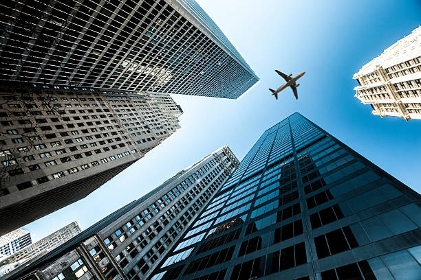 istock Airplane Over Business Towers 181102402