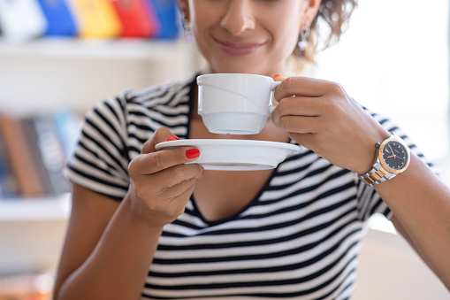 Woman enjoying a cup of coffee indoor
