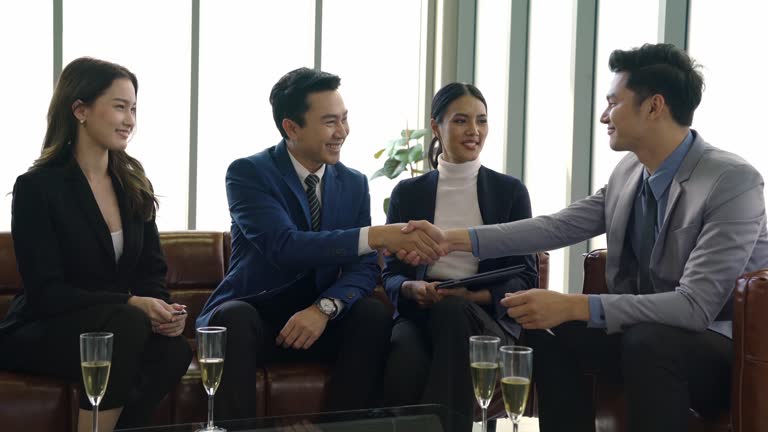 Small group of Business Person signing contract after conference with investor in modern office