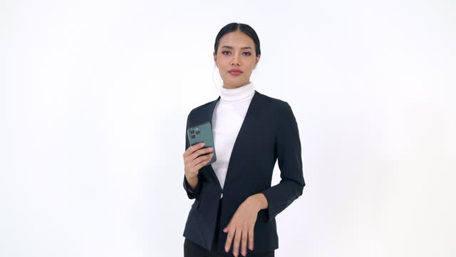 Portrait of Asian businesswoman in business suit using smartphone on white background.
